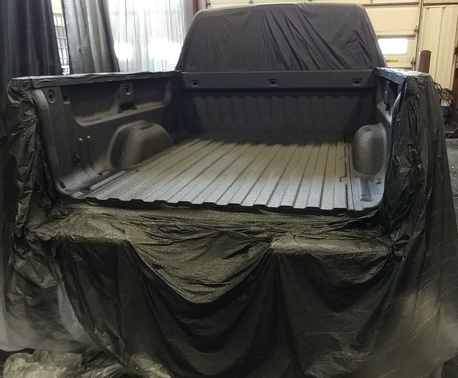 Applicator spraying stop rust coating on vehicle metal